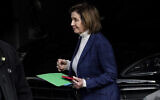 House Speaker Nancy Pelosi is escorted to a vehicle outside of her home in San Francisco, Friday, Nov. 4, 2022. (AP Photo/Jeff Chiu)