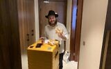 Eli Chitrik, 21 ans, tenant un bagel casher mis gratuitement à la disposition des fans juifs qui assistent à la Coupe du monde à Doha, au Qatar, le 23 novembre 2022. (Crédit : Ash Obel/The Times of Israel)