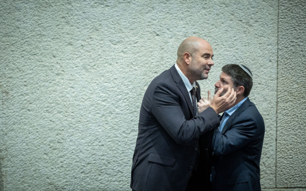 Le leader du sionisme religieux Bezalel Smotrich parle avec le député du Likud Amir Ohana pendant la session de la Knesset au cours de laquelle Ohana, le premier député ouvertement gay à remporter ce rôle, élu président de la Knesset. Smotrich, qui s'est déjà décrit comme un "fier homophobe", a voté pour cette nomination. (Crédit : Yonatan Sindel / Flash90) Le leader du sionisme religieux Bezalel Smotrich parle avec le député du Likud Amir Ohana pendant la session de la Knesset au cours de laquelle Ohana, le premier député ouvertement gay à remporter ce rôle, élu président de la Knesset. Smotrich, qui s'est déjà décrit comme un "fier homophobe", a voté pour cette nomination. (Crédit : Yonatan Sindel / Flash90)