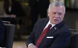 Le roi Abdallah II de Jordanie écoute le discours du président français pendant un déjeuner de travail au palais royal Al-Husseiniya à Amman, le 21 décembre 2022. (Crédit : Ludovic MARIN / POOL / AFP)