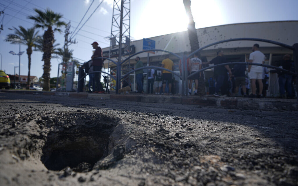 Le cratère d'une roquette interceptée, tirée depuis le Liban, qui a atterri sur la ville de Shlomi, dans le nord d'Israël, le 6 avril 2023. (Crédit : Ariel Schalit/AP Photo) Le cratère d'une roquette interceptée, tirée depuis le Liban, qui a atterri sur la ville de Shlomi, dans le nord d'Israël, le 6 avril 2023. (Crédit : Ariel Schalit/AP Photo)