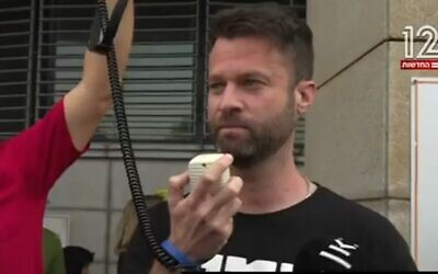 Roee Neuman, leader de la manifestation anti-réforme, s'exprimant après avoir été interrogé par la police, le 10 avril 2023. (Crédit : Capture d'écran de la Douzième chaîne)