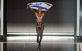 L'Israélienne Noa Kirel d’Israël, lors de la cérémonie des drapeaux, avant la Grande Finale du Concours de la chanson Eurovision à Liverpool, en Angleterre, le 13 mai 2023. (Crédit : AP Photo/Martin Meissner)