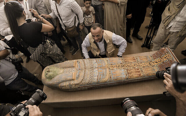 Mostafa Waziri, secrétaire général du Conseil suprême des antiquités, montrant un ancien sarcophage en bois récemment mis au jour sur le site de la pyramide à degrés de Djéser à Saqqara, en Égypte, le 27 mai 2023. (Crédit : AP Photo/Amr Nabil)