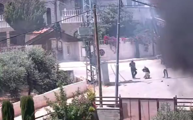 Des résidents d'implantations israéliennes armés sont vus en train d'ouvrir le feu dans la ville de Turmus Ayya en Cisjordanie, le 21 juin 2023. (Crédit : Capture d'écran/Twitter) Des résidents d'implantations israéliennes armés sont vus en train d'ouvrir le feu dans la ville de Turmus Ayya en Cisjordanie, le 21 juin 2023. (Crédit : Capture d'écran/Twitter)