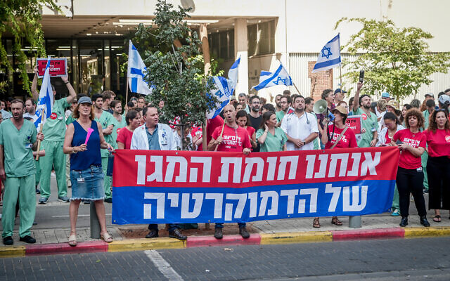 Le personnel médical protestant contre la réforme judiciaire, lors d'une grève de deux heures dans les hôpitaux d'Israël, à Tel Aviv, le 19 juillet 2023. (Crédit : Avshalom Sassoni/Flash90) Le personnel médical protestant contre la réforme judiciaire, lors d'une grève de deux heures dans les hôpitaux d'Israël, à Tel Aviv, le 19 juillet 2023. (Crédit : Avshalom Sassoni/Flash90)