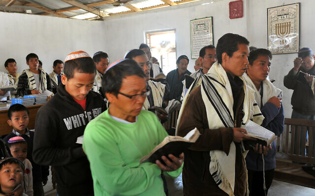 Des membres de la communauté locale des Bnei Menashe prient à la synagogue Beith Shalom lors d'un shabbat, le 18 février 2012, au centre hébraïque Shavei Israel, dans le district de Churachandpur, dans l'État indien de Manipur, au nord-est du pays. (Crédit : Manjunath KIRAN / AFP)