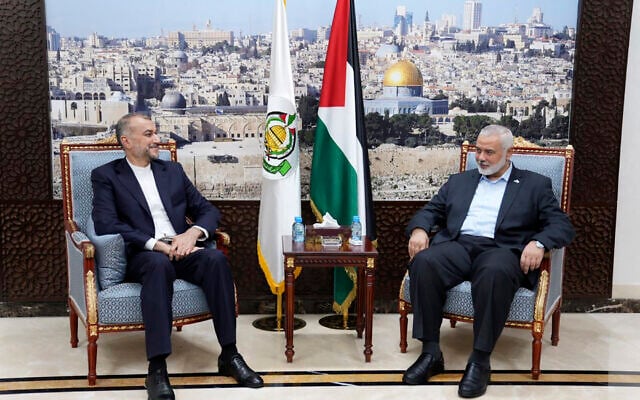 Le ministre des Affaires étrangères de l'Iran, Hossein Amir-Aabdollahian (à gauche) rencontrant Ismaïl Haniyeh, l'un des dirigeants du groupe terroriste palestinien Hamas à Doha, au Qatar, le 14 octobre 2023. (Crédit : ministère des Affaires étrangères iranien/AP)