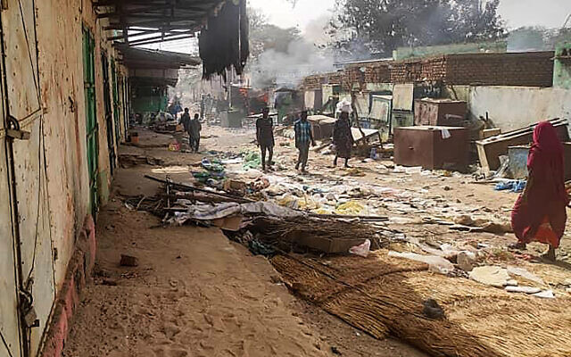 Des personnes marchant parmi des objets éparpillés, alors que les combats se poursuivent au Soudan entre les forces de deux généraux rivaux , marché d'al-Geneina, la capitale du Darfour occidental, le 29 avril 2023. (Crédit : AFP) Des personnes marchant parmi des objets éparpillés, alors que les combats se poursuivent au Soudan entre les forces de deux généraux rivaux , marché d'al-Geneina, la capitale du Darfour occidental, le 29 avril 2023. (Crédit : AFP)