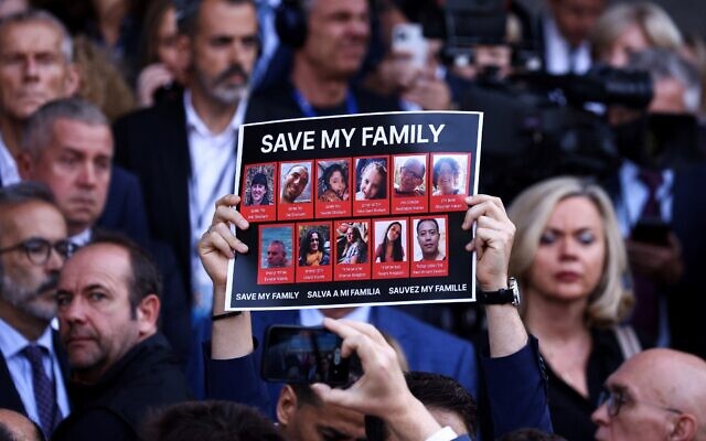Des personnes tenant des pancartes sur lesquelles on peut lire "Sauvez ma famille" lors d'un hommage aux victimes des attaques organisées par le Hamas en Israël, au Parlement européen à Bruxelles, le 11 octobre 2023. (Crédit : Kenzo Tribouillard/AFP)