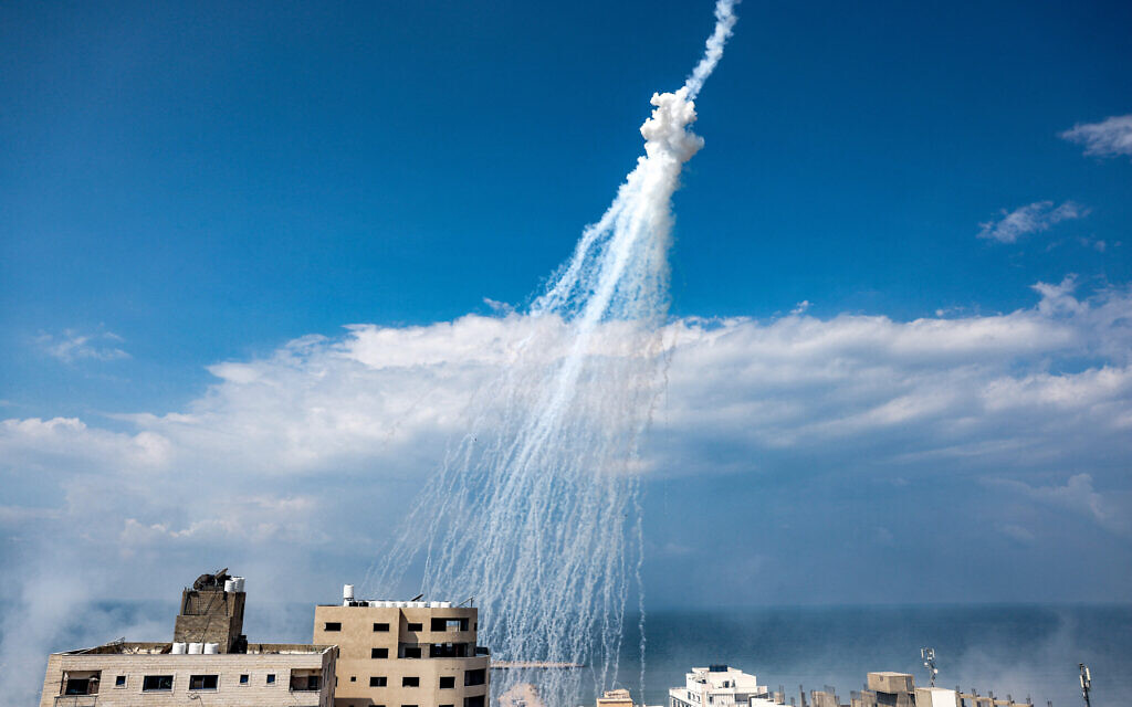 De la fumée des bombardements israéliens au-dessus du port maritime de Gaza, le 11 octobre 2023. (Crédit : Mohammed Abed/AFP)