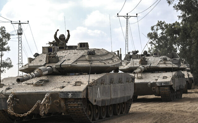 Un soldat israélien dans un tank Merkava à la frontière avec la bande de Gaza, dans le sud d'Israël, le 13 octobre 2023. (Crédit : Aris Messinis/AFP)