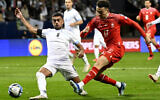 Le joueur israélien Raz Shlomo, à gauche, tente de bloquer le joueur suisse Ruben Vargas lors du match de football de qualification pour le groupe I de l'Euro 2024 entre Israël et la Suisse à la Pancho Arena de Felcsut, en Hongrie, le mercredi 15 novembre 2023. (Crédit : AP/Denes Erdos)