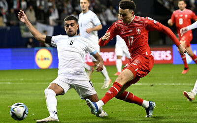 Le joueur israélien Raz Shlomo, à gauche, tente de bloquer le joueur suisse Ruben Vargas lors du match de football de qualification pour le groupe I de l'Euro 2024 entre Israël et la Suisse à la Pancho Arena de Felcsut, en Hongrie, le mercredi 15 novembre 2023. (Crédit : AP/Denes Erdos)
