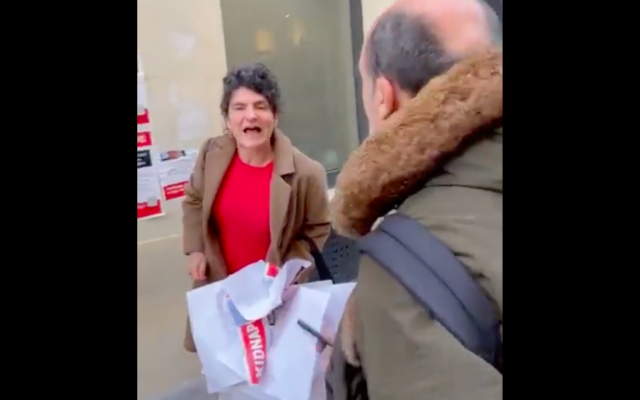 Capture d’écran d’une vidéo postée sur X montrant Sophie Pommier arrachant des affiches à Paris pour les plus de 240 otages à Gaza tout en criant « Israël assassin ». (Crédit : Meyer Habib / Twitter)