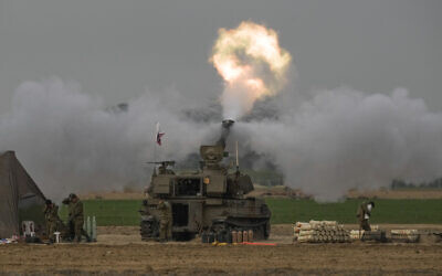 Une unité d'artillerie mobile de l’armée israélienne tirant un obus du sud d'Israël vers la bande de Gaza, d'une position à proximité de la frontière entre Israël et Gaza, le 10 décembre 2023. (Crédit : Leo Correa/AP)