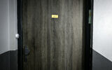 Une croix gammée gravée sur la porte de l'appartement, qui porte une mezouza, où une femme juive a été poignardée la veille, à Lyon, en France, le 5 novembre 2023. (Crédit : Jeff Pachoud AFP)