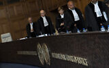 La présidente de la Cour internationale de Justice Joan Donoghue, au centre, et d'autres juges entrent à la Cour mondiale de La Haye, le 6 juin 2023. (Crédit : AP Photo/Peter Dejong)