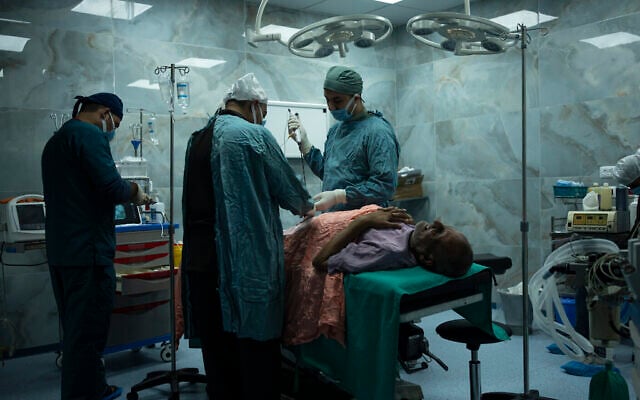 Dr. Suhaib Alhamss, le directeur de l'Hôpital Koweïtien dans la ville du sud de Rafah à Gaza, effectue une intervention chirurgicale sur un patient, le 11 janvier 2024. (Crédit : AP/Fatima Shbair) Dr. Suhaib Alhamss, le directeur de l'Hôpital Koweïtien dans la ville du sud de Rafah à Gaza, effectue une intervention chirurgicale sur un patient, le 11 janvier 2024. (Crédit : AP/Fatima Shbair)