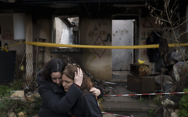 Amit Soussana, à droite, embrassée par une amie devant sa maison détruite, au kibboutz Kfar Aza, le 29 janvier 2024. (Crédit : Leo Correa/AP Photo) Amit Soussana, à droite, embrassée par une amie devant sa maison détruite, au kibboutz Kfar Aza, le 29 janvier 2024. (Crédit : Leo Correa/AP Photo)