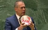 L'envoyé israélien à l'ONU, Gilad Erdan, présente un gâteau à Kfir Bibas à l'occasion de son premier anniversaire en captivité avec le Hamas à Gaza, à l'ONU, le 9 janvier 2024. (Capture d'écran/Channel 12, utilisée conformément à l'article 27a de la loi sur le droit d'auteur)