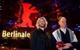 Le cinéaste américain Ben Russell (à droite) et le cinéaste français Guillaume Cailleau posant avec le prix Encounters du meilleur film pour leur film "Direct Action" sur le tapis rouge après la cérémonie de remise des prix de la 74e édition du Festival international du film de Berlin, à Berlin, le 24 février 2024. (Crédit : Tobias Schwarz/AFP)