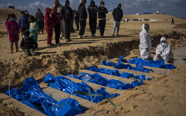 Des Palestiniens enterrant les corps de personnes tuées lors de combats avec Israël et renvoyées à Gaza par l'armée israélienne, lors de funérailles collectives, à Rafah, dans la bande de Gaza, le 30 janvier 2024. (Crédit : Fatima Shbair/AP) Des Palestiniens enterrant les corps de personnes tuées lors de combats avec Israël et renvoyées à Gaza par l'armée israélienne, lors de funérailles collectives, à Rafah, dans la bande de Gaza, le 30 janvier 2024. (Crédit : Fatima Shbair/AP)