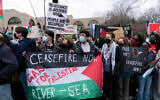 Des manifestants tenant un drapeau palestinien avec les mots "CEASEFIRE NOW ; Gays for Palestine ; RIVER - SEA". lors d'un rassemblement pro-palestinien et anti-Israël, devant l'ambassade d'Israël, à Washington, le 2 mars 2024. (Crédit : Jose Luis Magana/AP)