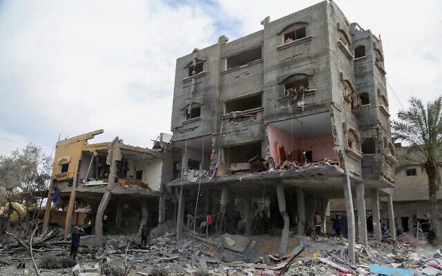 Des Palestiniens inspectant les décombres après une frappe israélienne à l'ouest du camp de réfugiés de Nuseirat, dans le centre de la bande de Gaza, le 16 mars 2024. (Crédit : AFP)
