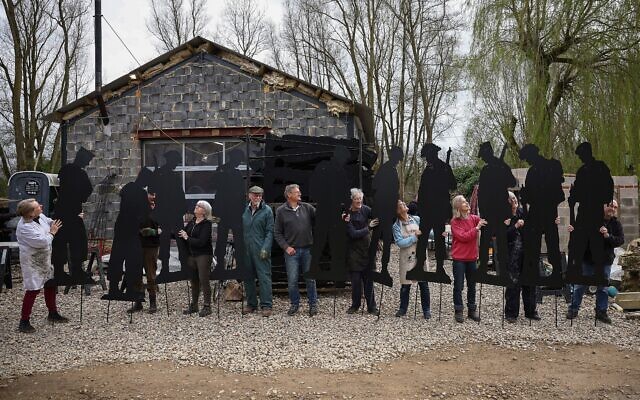 Des volontaires posent avec des silhouettes de soldats de la Seconde Guerre mondiale qui formeront ensemble l'exposition « Standing with Giants » de l’artiste Dan Barton en Normandie, à Cutmill Farm, à Stanton Harcourt, dans le centre de l'Angleterre, le 22 mars 2024. (Crédit : HENRY NICHOLLS / AFP) Des volontaires posent avec des silhouettes de soldats de la Seconde Guerre mondiale qui formeront ensemble l'exposition « Standing with Giants » de l’artiste Dan Barton en Normandie, à Cutmill Farm, à Stanton Harcourt, dans le centre de l'Angleterre, le 22 mars 2024. (Crédit : HENRY NICHOLLS / AFP)