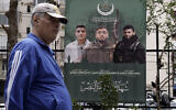 Un homme passe devant une affiche montrant les membres du groupe terroriste Jamaa al-Islamiya qui ont été tués lors d'une frappe israélienne à Beyrouth, au Liban, le 26 mars 2024. (Crédit :AP/Bilal Hussein)