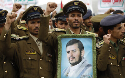 Des partisans des Houthis, avec une photo du chef houthi Abdul Malik al-Houthi, lors d’un rassemblement en soutien aux Palestiniens dans la bande de Gaza et contre les frappes menées par les États-Unis contre le Yémen, à Sanaa, le 16 février 2024. (Crédit : Osamah Abdulrahman/AP)