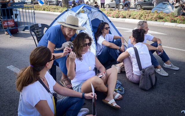 Une femme fumant une cigarette lors d'une manifestation appelant à la libération des personnes prises en otage par les terroristes du Hamas à Gaza, devantles quartiers généraux de l'armée de la Kirya, à Tel Aviv, le 3 novembre 2023. (Crédit : Avshalom Sassoni/Flash90)