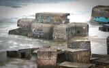 Des bunkers du mur de l'Atlantique, partiellement submergés dans le sable à Vigso, dans l'ouest du Danemark, le 13 avril 2024. (Crédit : Olivier MORIN / AFP)
