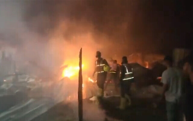 Capture d'écran d'une vidéo filmée par un bénévole du Croissant rouge montrant un incendie dans un camp pour Palestiniens déplacés à Rafah, dans le sud de Gaza, suite à une frappe israélienne contre un complexe qui, a affirmé Tsahal, était utilisé par le Hamas, le 26 mai 2024. (Crédit : PRCS/AFP) Capture d'écran d'une vidéo filmée par un bénévole du Croissant rouge montrant un incendie dans un camp pour Palestiniens déplacés à Rafah, dans le sud de Gaza, suite à une frappe israélienne contre un complexe qui, a affirmé Tsahal, était utilisé par le Hamas, le 26 mai 2024. (Crédit : PRCS/AFP)