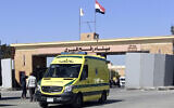 Une ambulance transportant les corps des travailleurs humanitaires étrangers tués lors d'une récente frappe aérienne israélienne à Gaza traverse le poste frontière de Rafah entre l'Égypte et la bande de Gaza, mercredi 3 avril 2024. (Crédit : Ahmed Abudraa/AP)