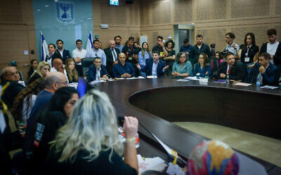 Des proches d'Israéliens retenus en otage dans la bande de Gaza défient le ministre des Finances Bezalel Smotrich lors d'une réunion de la commission des finances de la Knesset, le 10 juin 2024. (Chaim Goldberg/Flash90)