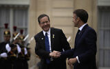 Le président français Emmanuel Macron, à droite, serre la main du président israélien Isaac Herzog après leur rencontre au Palais de l'Élysée, avant la cérémonie d'ouverture des Jeux olympiques d'été de 2024, le vendredi 26 juillet 2024, à Paris, en France. (Crédit : AP Photo/Louise Delmotte)