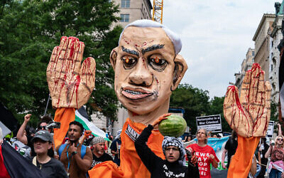 Des manifestants anti-Israël brandissant une effigie du Premier ministre Benjamin Netanyahu protestant à proximité de la Maison Blanche pour dénoncer la rencontre du président américain Joe Biden avec Netanyahu, à Washington, le 25 juillet 2024. (Crédit : Andrew Thomas/AFP)