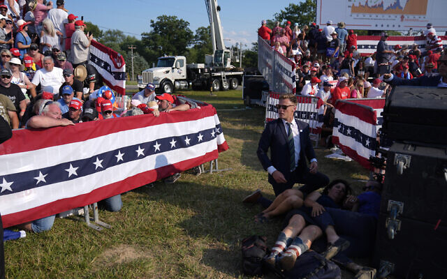 Des gens à terre pendant un rassemblement de campagne avec le candidat républicain à la présidence, l'ancien président Donald Trump, pendant un rassemblement de campagne à Butler, en Pennsylvanie, le 13 juillet 2024. (Crédit : (AP Photo/Evan Vucci)