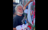 Denis Laurent, ancien conseiller municipal EELV de Saint-Maur des Fossés (Val-de-Marne), arrache une affiche de Kfir Bibas, bébé otage à Gaza, en juillet 2024. (Crédit : Capture d’écran X)