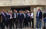 Le Premier ministre français Gabriel Attal (C), accompagné du ministre de l'Intérieur Gérald Darmanin et de députés français, sortent de la synagogue incendiée à La Grande-Motte, France, 24 août 2024. (Crédit : Pascal Guyot/AFP)