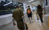 Illustration : Des soldats israéliens blessés lors de la guerre contre le Hamas marchant dans l'unité de rééducation de l'hôpital Sheba, à Ramat Gan, le 18 décembre 2023. (Crédit : Oded Balilty/AP)
