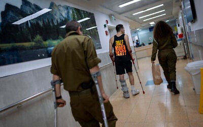 Illustration : Des soldats israéliens blessés lors de la guerre contre le Hamas marchant dans l'unité de rééducation de l'hôpital Sheba, à Ramat Gan, le 18 décembre 2023. (Crédit : Oded Balilty/AP)