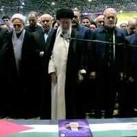 L'ayatollah Ali Khamenei prononçant les prières au-dessus du cercueil du chef du Hamas Ismaïl Haniyeh, le nouveau président iranien Masoud Pezeshkian se tenant à sa droite, à l'Université de Téhéran, le 1er août 2024. (Crédit : Capture d'écran/AFP)
