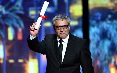 (FILES) Iranian director and producer Mohammad Rasoulof arrives on stage after he was awarded with a Special Jury Prize for the film "The Seed of the Sacred Fig" during the Closing Ceremony at the 77th edition of the Cannes Film Festival in Cannes, southern France, on May 25, 2024. - Iranian director and producer Mohammad Rasoulof's film "The Seed of the Sacred Fig" is set to be released in France on September 18, 2024. (Photo by Christophe SIMON / AFP)