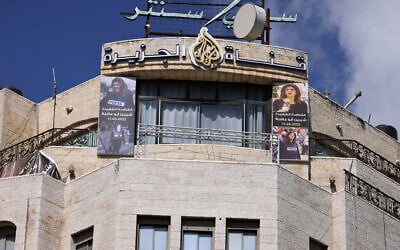 Des photos de la journaliste d'Al-Jazeera tuée, Shireen Abu Akleh, ornent la façade du bâtiment de la chaîne de télévision à Ramallah, en Cisjordanie, après qu'Israël a émis un ordre de fermeture de 45 jours, le 22 septembre 2024. (Crédit : Jaafar Ashtiyeh/AFP)