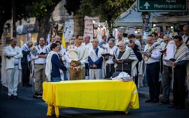 Des Juifs priant en mémoire des victimes du pogrom du 7 octobre et pour la libération des Israéliens retenus en otage dans la bande de Gaza, le matin de la fête juive de Simhat Torah, à Jérusalem, le 24 octobre 2024. (Crédit : Yonatan Sindel/Flash90)