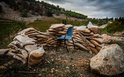 Une chaise est entourée de sacs de sable à Metula, du côté israélien de la frontière avec le Liban, le 20 novembre 2024. (Crédit : David Cohen/Flash90)