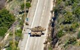 Un char de combat de l'armée israélienne se déplaçant sur une route à l'entrée du village de Hula, le long de la frontière avec Israël, sur une photo prise dans le village de Chaqra, au sud du Liban, le 25 janvier 2025. (Crédit : AFP)